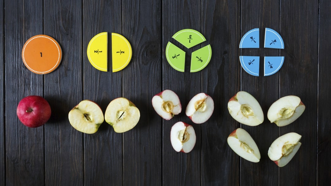 Fraction magents lying next to slices of apple