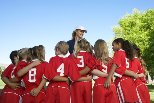 woman coach leading girls football