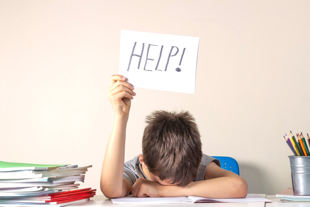 boy at desk needing help with mental health